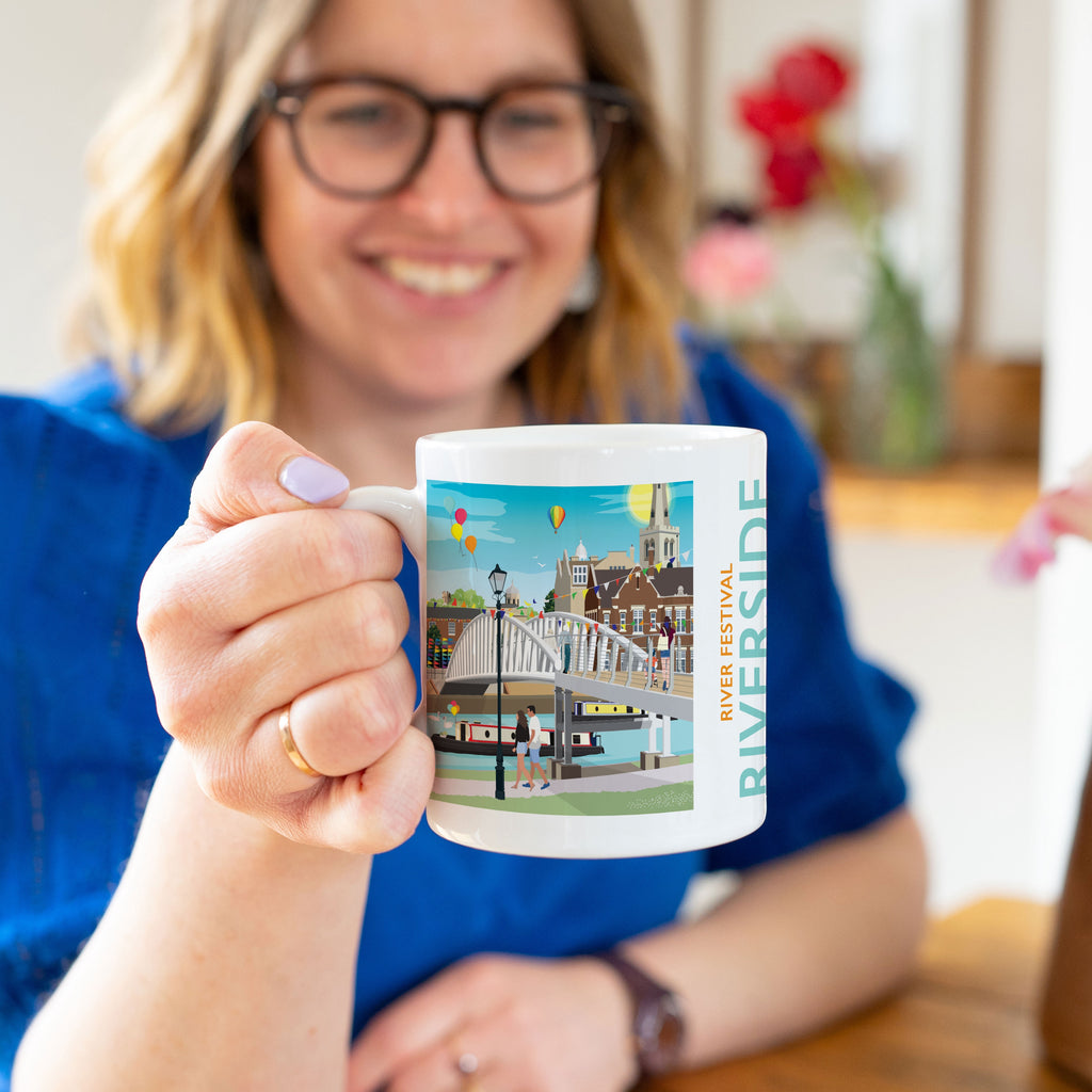 a woman holding a coffee mug with a picture of a city