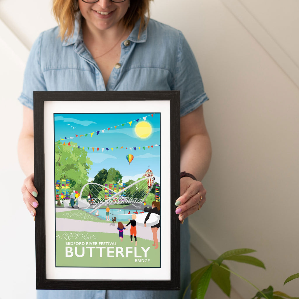 a woman holding a picture of a butterfly park