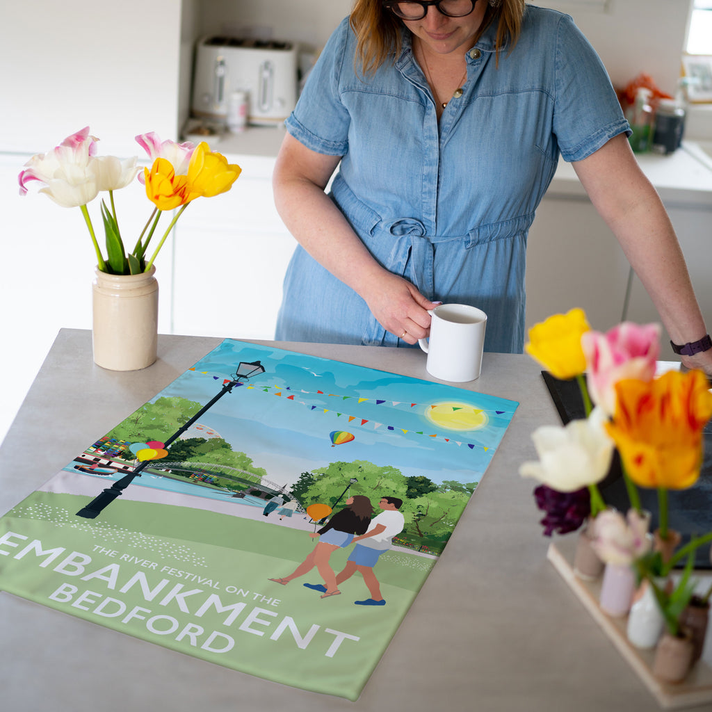 a woman in a blue shirt is holding a cup